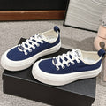 CHANEL LACE-UP SNEAKERS IN NAVY BLUE CANVAS
